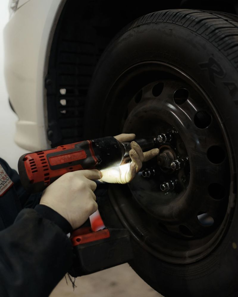Impact wrench on the lug nuts of a steel wheel